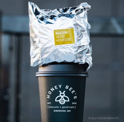 Foil-wrapped food on a Honey Bee's branded cup with a blurred background
