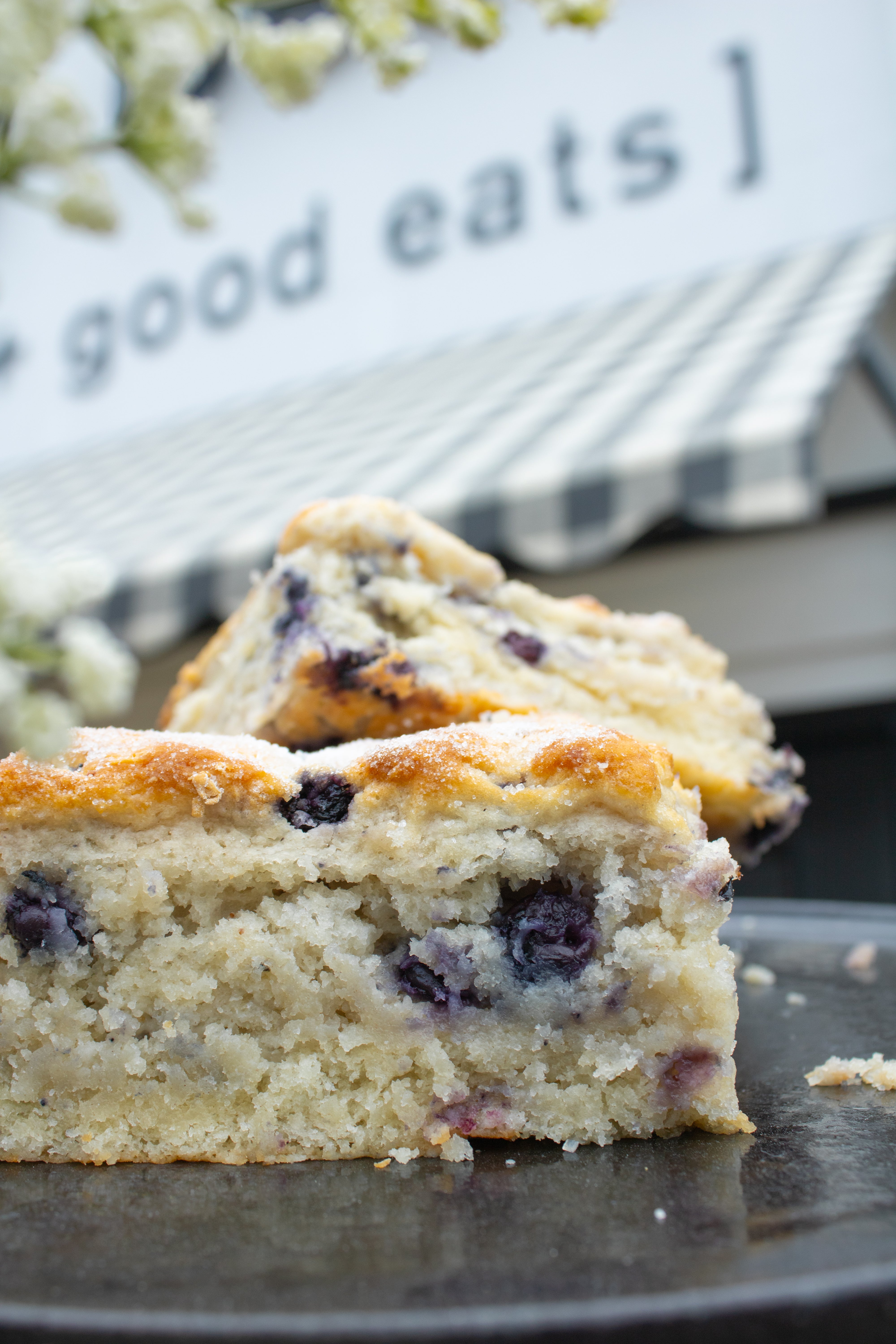 Blueberry biscuits on a plate with 'good eats' sign in the background