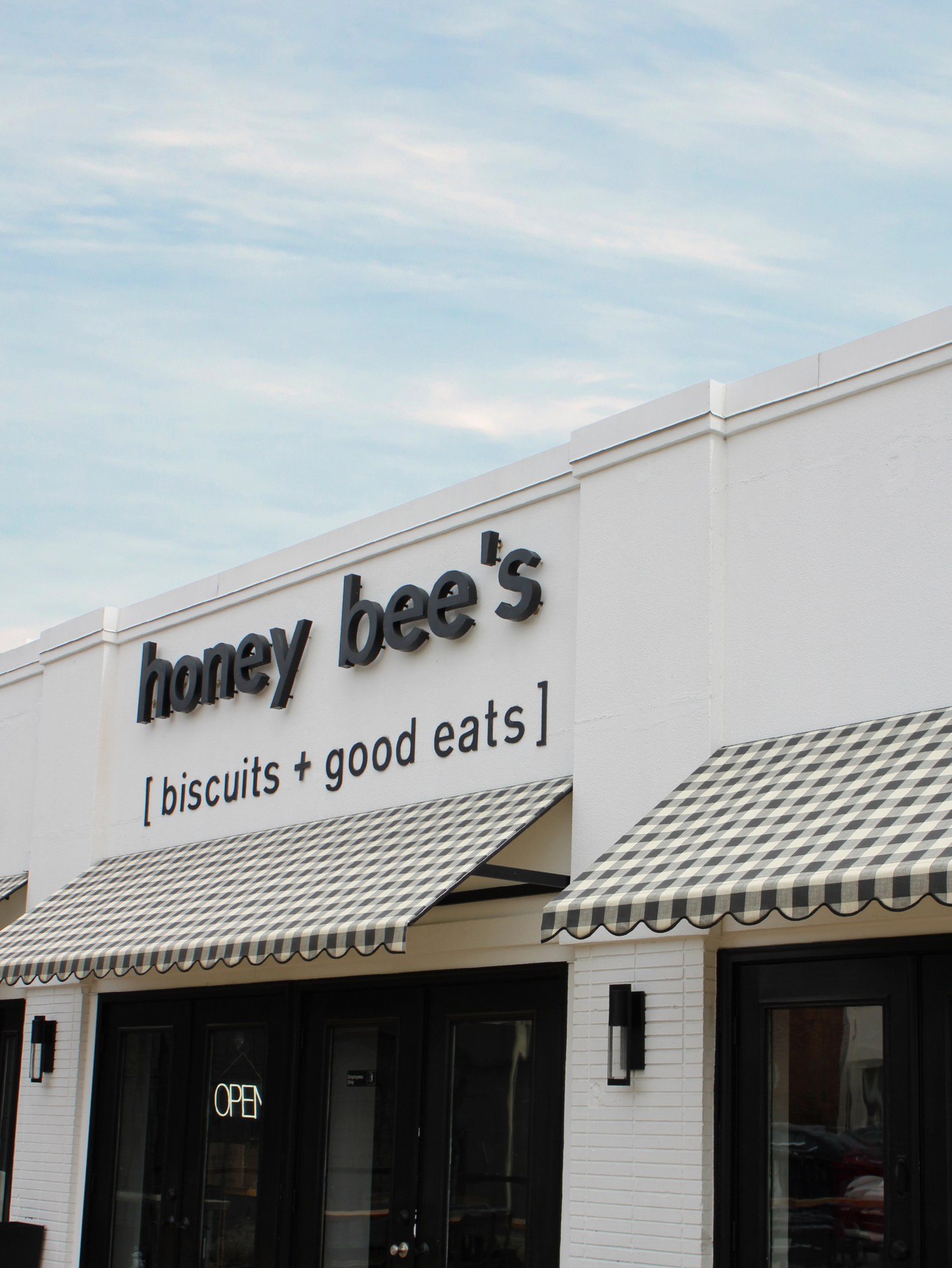 Storefront of 'honey bee's' with a sign above the entrance.