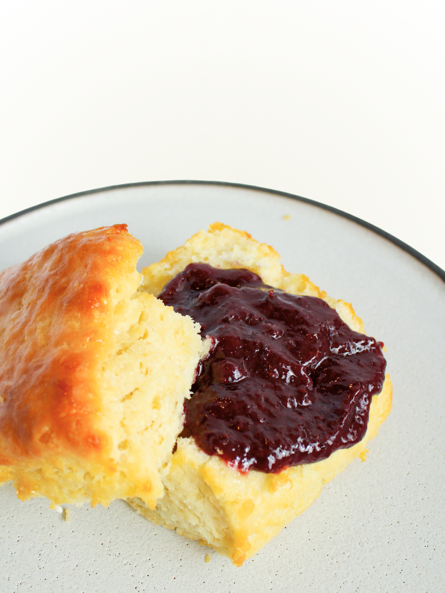 biscuit with jam on a white plate and white background
